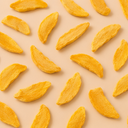 Pattern of yellow dried mango slices on a beige background
